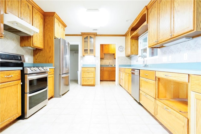 kitchen with stainless steel appliances, tasteful backsplash, ornamental molding, and sink