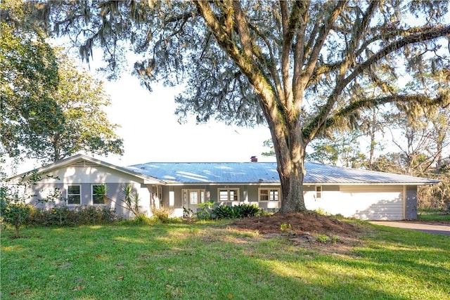 ranch-style house with a garage and a front lawn