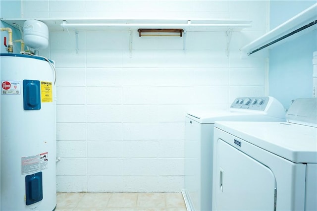 clothes washing area featuring separate washer and dryer and water heater