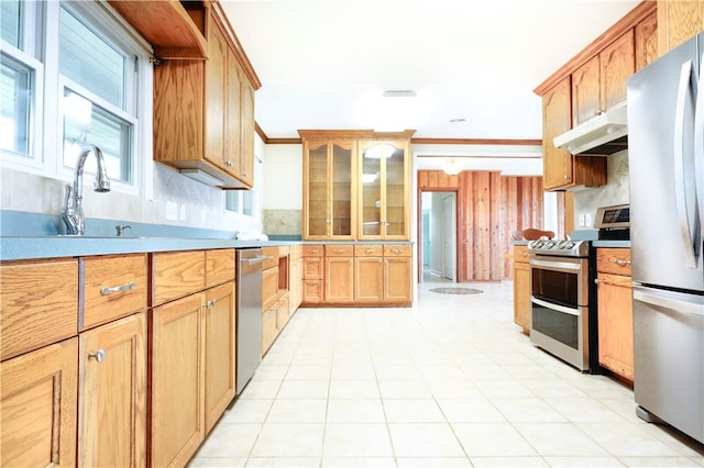 kitchen featuring decorative backsplash, ornamental molding, stainless steel appliances, sink, and light tile patterned flooring