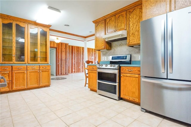 kitchen featuring decorative backsplash, crown molding, and appliances with stainless steel finishes