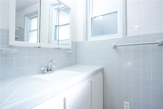 bathroom with tasteful backsplash and vanity