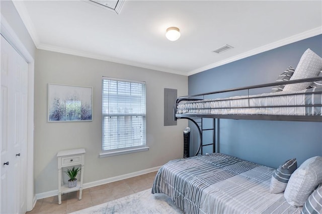 bedroom with light tile patterned floors, a closet, and ornamental molding