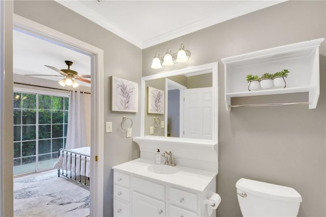 bathroom with ceiling fan, crown molding, vanity, and toilet