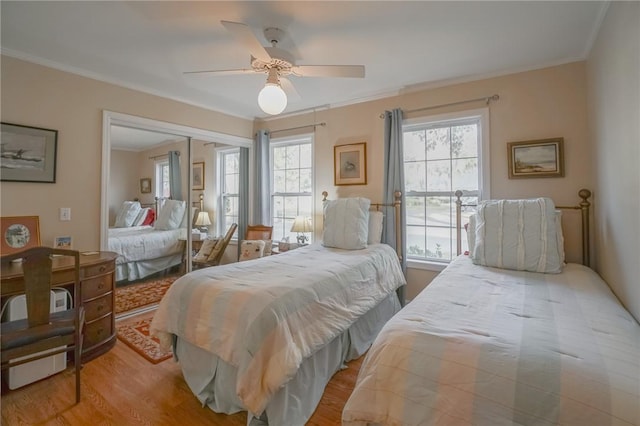 12 Wimbledon Ct, Saint Simons Island, GA 31522 - bedroom featuring wood finished floors, crown molding, a closet, and ceiling fan