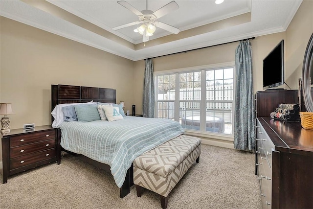 257 Villager Dr, Saint Simons Island, GA 31522 - bedroom featuring light colored carpet, a tray ceiling, ornamental molding, and a ceiling fan