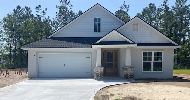 409 Country Walk Cir, Brunswick, GA 31525 - view of front of home featuring roof with shingles, a garage, concrete driveway, and stucco siding