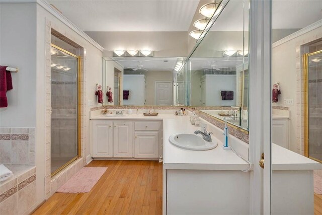 1064 Sea Palms W Dr, Saint Simons Island, GA 31522 - bathroom featuring double vanity, a stall shower, and wood finished floors
