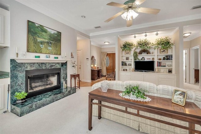 1064 Sea Palms W Dr, Saint Simons Island, GA 31522 - carpeted living room featuring a premium fireplace, ceiling fan, and crown molding