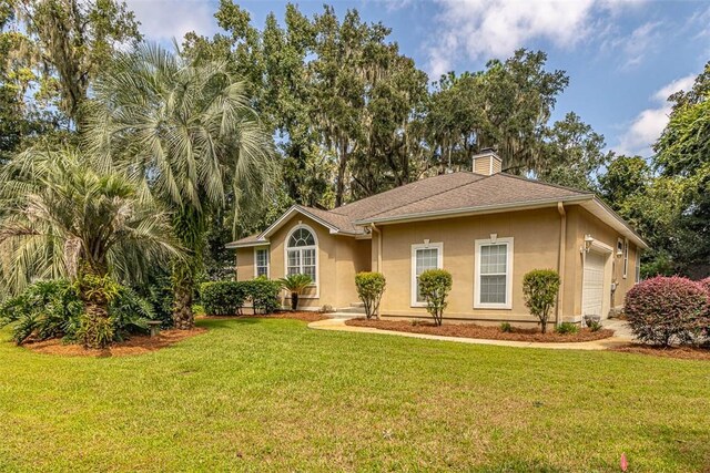 1064 Sea Palms W Dr, Saint Simons Island, GA 31522 - ranch-style house with an attached garage, stucco siding, a front yard, and a chimney