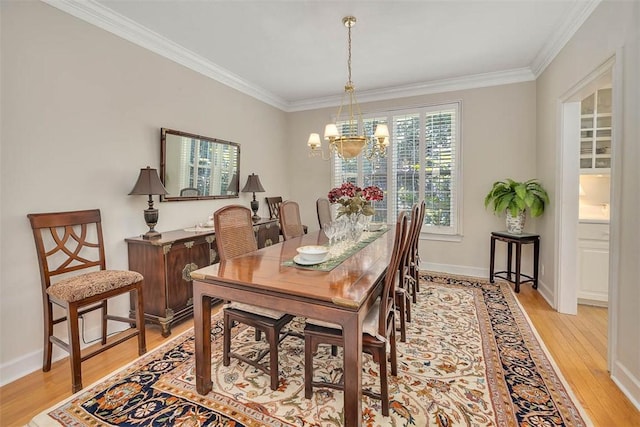 1064 Sea Palms W Dr, Saint Simons Island, GA 31522 - dining area with a chandelier, light wood-style flooring, and crown molding