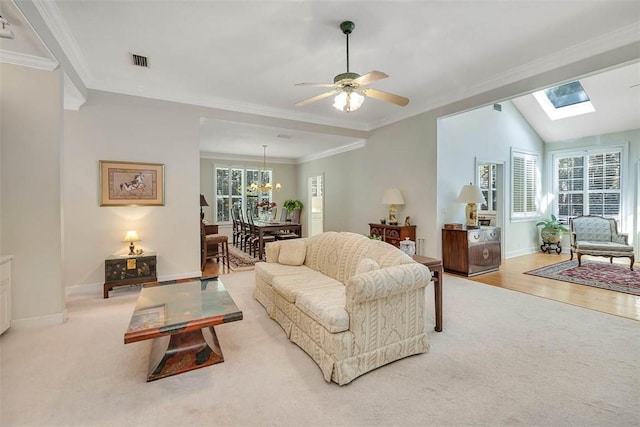 1064 Sea Palms W Dr, Saint Simons Island, GA 31522 - living area with light colored carpet, ornamental molding, a chandelier, ceiling fan, and a skylight