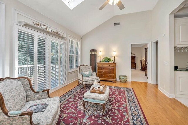 1064 Sea Palms W Dr, Saint Simons Island, GA 31522 - sitting room featuring a ceiling fan, vaulted ceiling, light wood-style floors, and a skylight