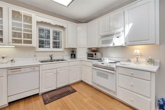 1064 Sea Palms W Dr, Saint Simons Island, GA 31522 - kitchen featuring white appliances, white cabinets, light wood-type flooring, and light countertops