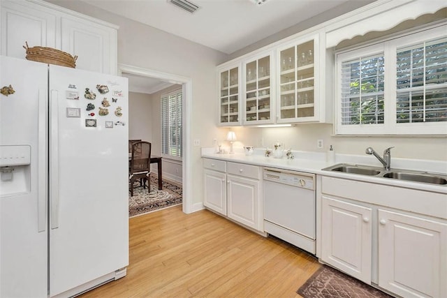 1064 Sea Palms W Dr, Saint Simons Island, GA 31522 - kitchen featuring white appliances, light wood-style floors, white cabinetry, and glass insert cabinets