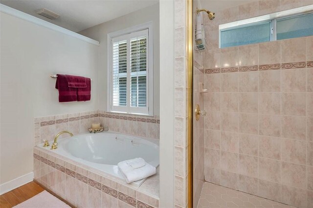 1064 Sea Palms W Dr, Saint Simons Island, GA 31522 - full bathroom featuring a garden tub, a shower stall, and wood finished floors