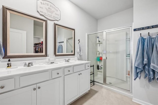 bathroom with tile patterned floors, vanity, and walk in shower