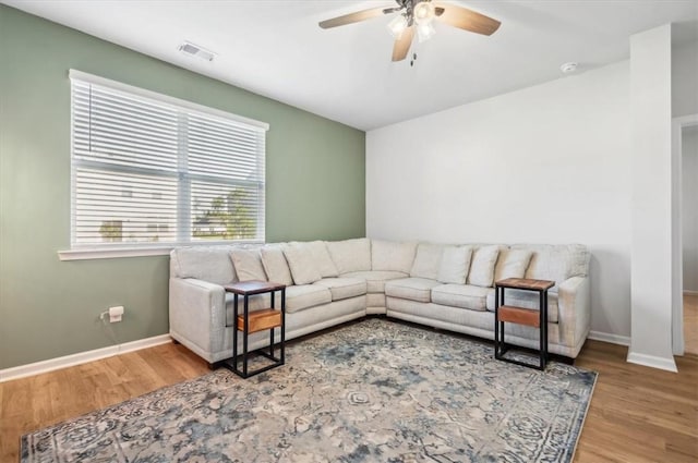 living room featuring hardwood / wood-style floors and ceiling fan