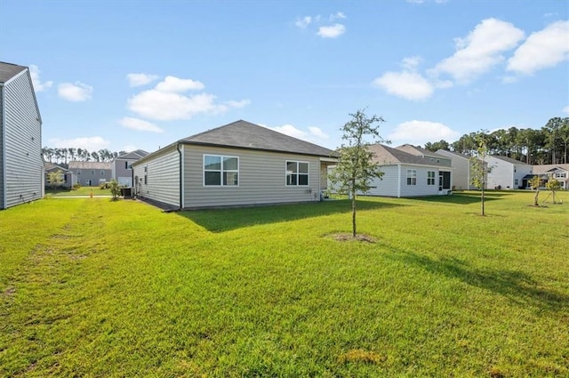 rear view of property featuring a yard