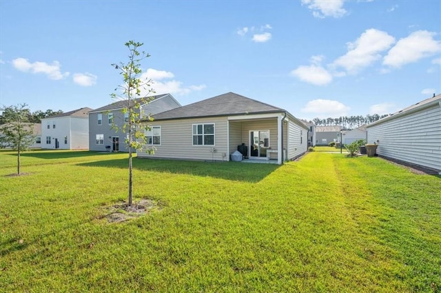 rear view of house with a lawn