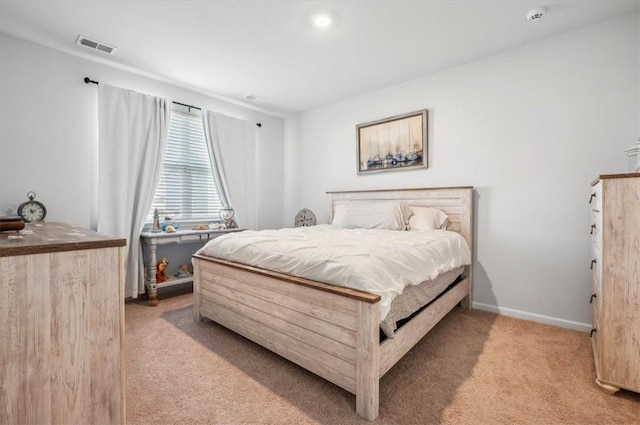 bedroom featuring light carpet