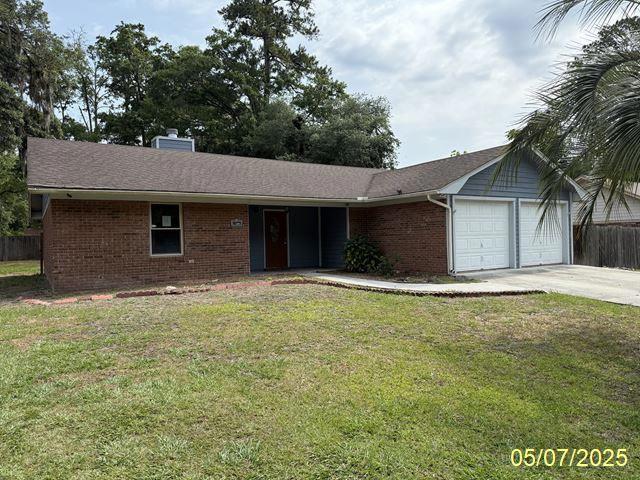 164 W Holly Ave, Kingsland, GA 31548 - ranch-style home featuring brick siding, an attached garage, driveway, and a chimney