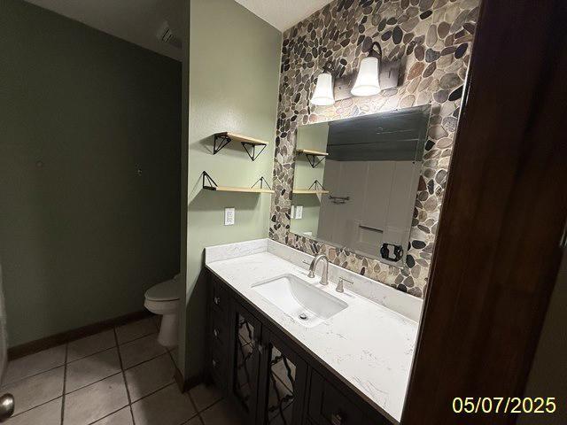 164 W Holly Ave, Kingsland, GA 31548 - bathroom featuring vanity, toilet, tile patterned floors, and baseboards