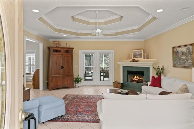 117 Serenoa Dr, Brunswick, GA 31523 - tiled living room featuring a raised ceiling, healthy amount of natural light, a fireplace, ornamental molding, and ceiling fan