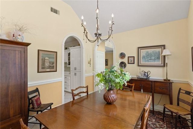 117 Serenoa Dr, Brunswick, GA 31523 - tiled dining area featuring arched walkways, vaulted ceiling, and a chandelier