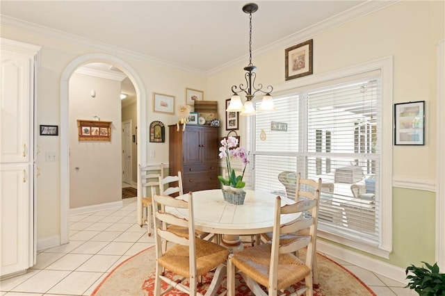 117 Serenoa Dr, Brunswick, GA 31523 - dining room featuring light tile patterned flooring, arched walkways, crown molding, and a chandelier