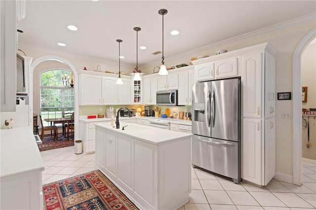 117 Serenoa Dr, Brunswick, GA 31523 - kitchen featuring stainless steel appliances, arched walkways, light tile patterned flooring, white cabinetry, and crown molding