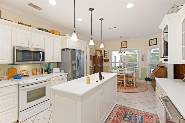 117 Serenoa Dr, Brunswick, GA 31523 - kitchen featuring appliances with stainless steel finishes, light tile patterned floors, light countertops, a center island with sink, and crown molding