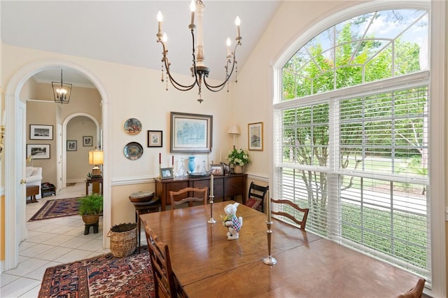 117 Serenoa Dr, Brunswick, GA 31523 - dining space featuring a chandelier, arched walkways, light tile patterned floors, and lofted ceiling