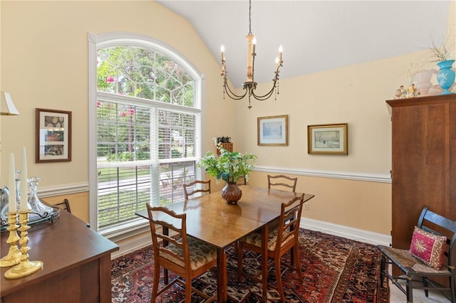 117 Serenoa Dr, Brunswick, GA 31523 - dining area featuring a chandelier, vaulted ceiling, and plenty of natural light