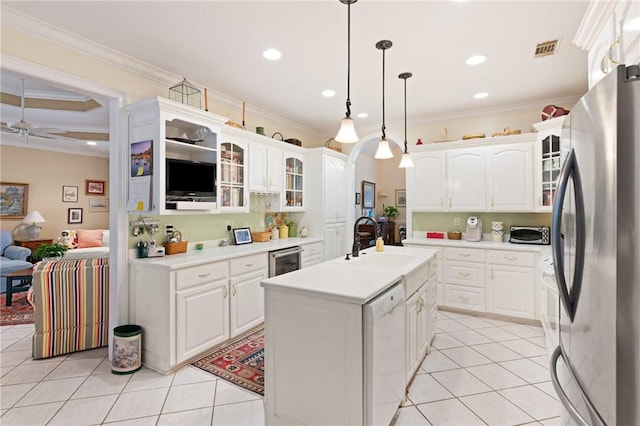 117 Serenoa Dr, Brunswick, GA 31523 - kitchen with freestanding refrigerator, white dishwasher, light tile patterned flooring, ornamental molding, and recessed lighting