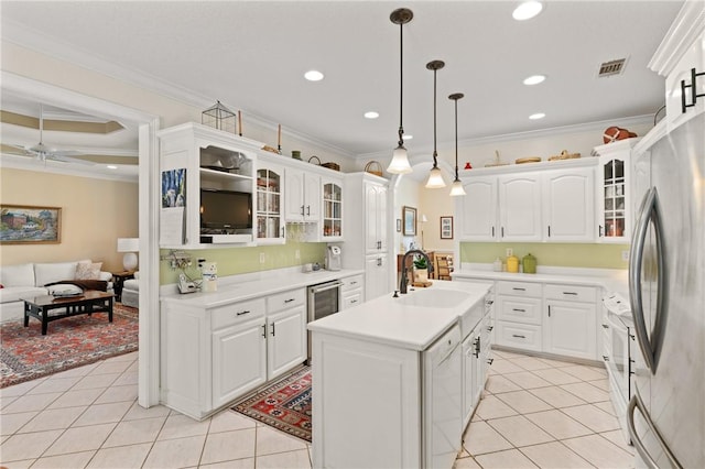 117 Serenoa Dr, Brunswick, GA 31523 - kitchen featuring freestanding refrigerator, light tile patterned floors, crown molding, glass insert cabinets, and light countertops