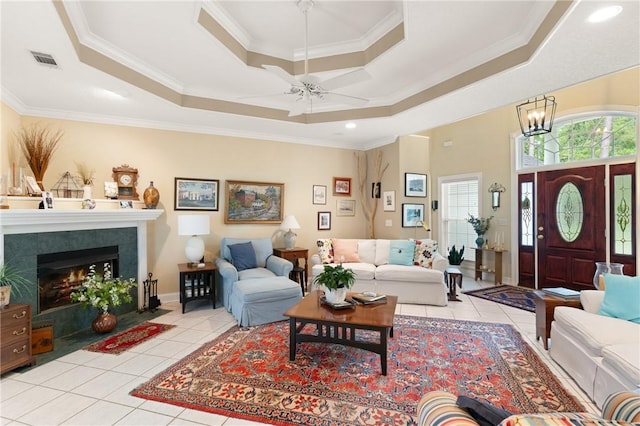 117 Serenoa Dr, Brunswick, GA 31523 - living area with a raised ceiling, light tile patterned floors, a ceiling fan, ornamental molding, and a fireplace