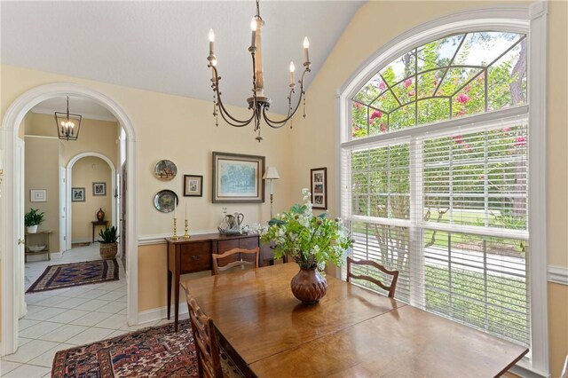 117 Serenoa Dr, Brunswick, GA 31523 - dining area with a chandelier, arched walkways, light tile patterned floors, and lofted ceiling