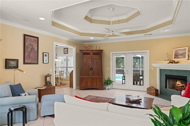 117 Serenoa Dr, Brunswick, GA 31523 - living room with french doors, light tile patterned floors, a raised ceiling, ceiling fan, and crown molding