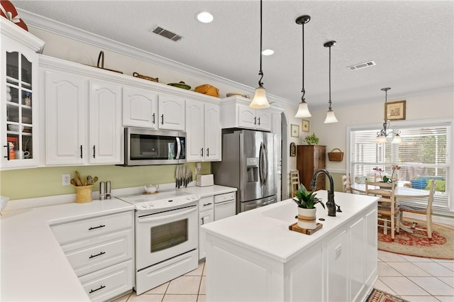 117 Serenoa Dr, Brunswick, GA 31523 - kitchen with stainless steel appliances, white cabinets, light tile patterned flooring, glass insert cabinets, and ornamental molding