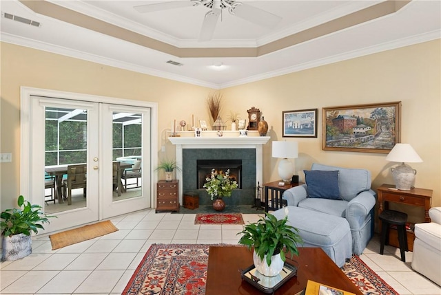 117 Serenoa Dr, Brunswick, GA 31523 - living area featuring french doors, light tile patterned floors, ceiling fan, crown molding, and a tray ceiling