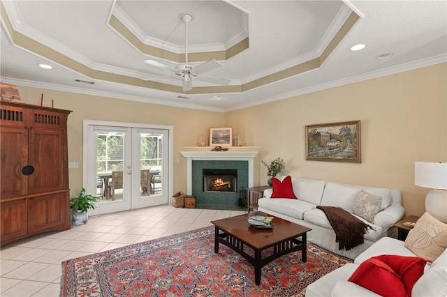 117 Serenoa Dr, Brunswick, GA 31523 - living room with a tray ceiling, a ceiling fan, light tile patterned flooring, ornamental molding, and french doors