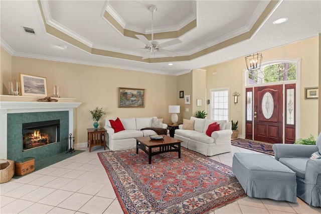 117 Serenoa Dr, Brunswick, GA 31523 - living room with a raised ceiling, a ceiling fan, light tile patterned floors, crown molding, and a fireplace