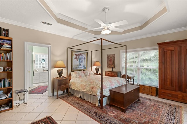 117 Serenoa Dr, Brunswick, GA 31523 - bedroom featuring a raised ceiling, crown molding, light tile patterned floors, and connected bathroom