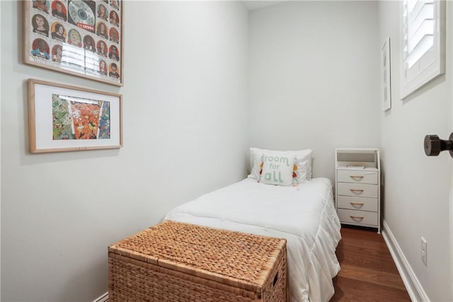 bedroom with wood finished floors and baseboards