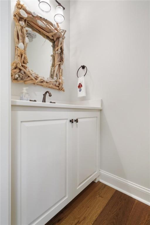 bathroom featuring wood finished floors and baseboards