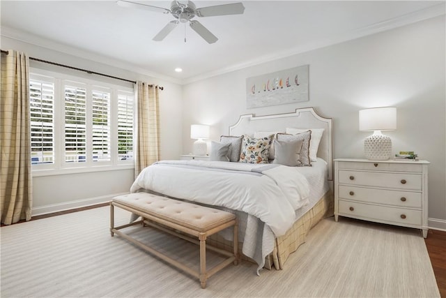 bedroom with baseboards, wood finished floors, a ceiling fan, and ornamental molding