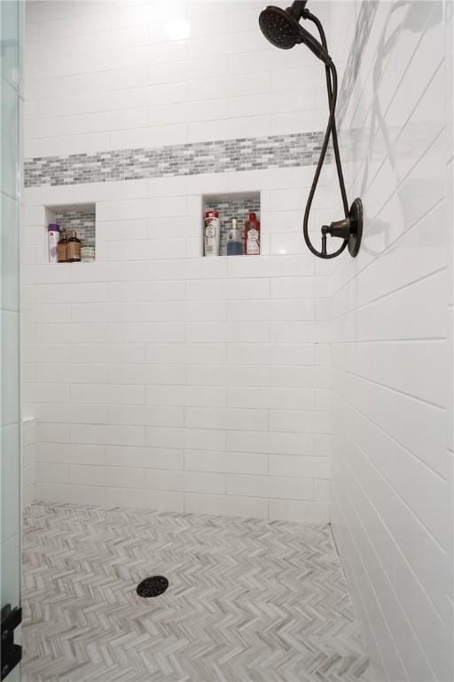 full bath with a tile shower