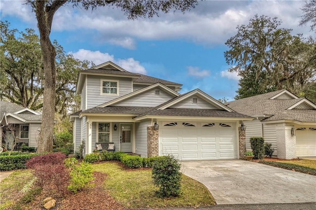 traditional home with concrete driveway, brick siding, a garage, and roof with shingles