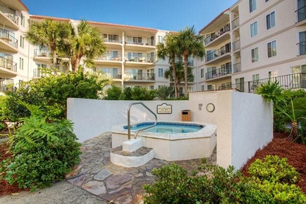 view of pool with a hot tub